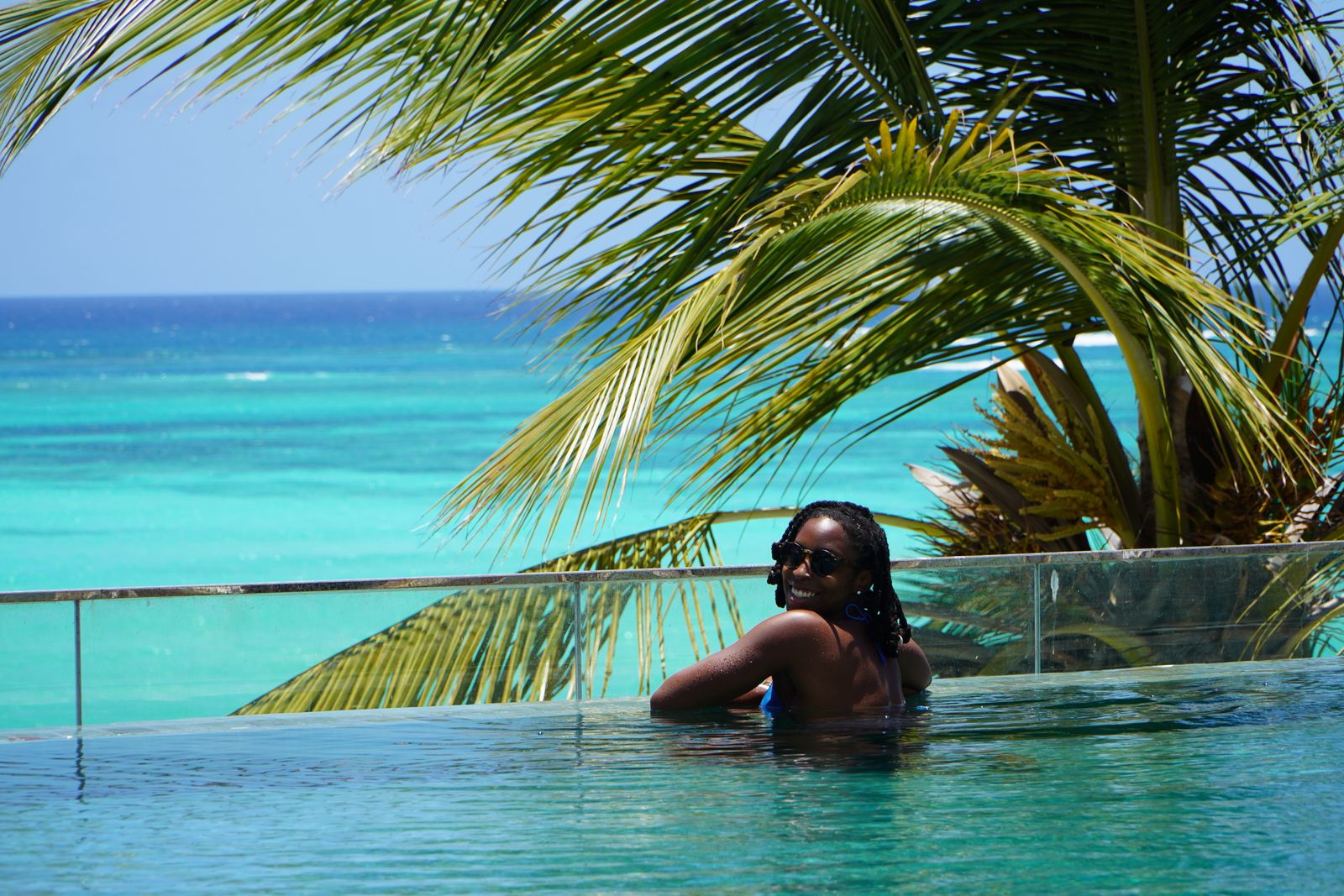 Infinity pool edge looking out over a turquoise ocean